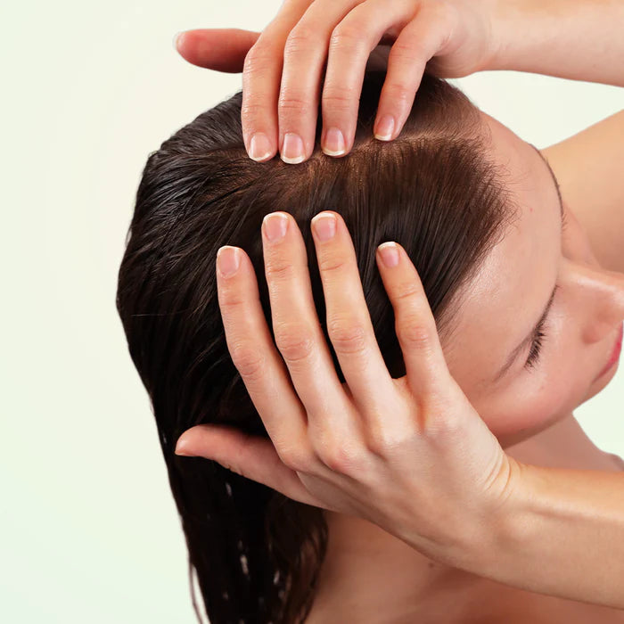 A girl massaging their head with hands 